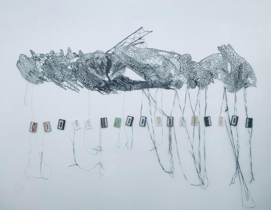 Pierre Fouché. Privy to Mysteries. 2024. Cassette Tapes of discarded religious sermons. 2.5 x 0.8m (main panel - installation dimensions variable).